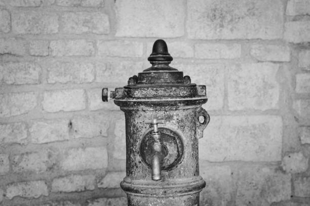 Isolated old drinking fountain on the street (Spello, Umbria, Italy)