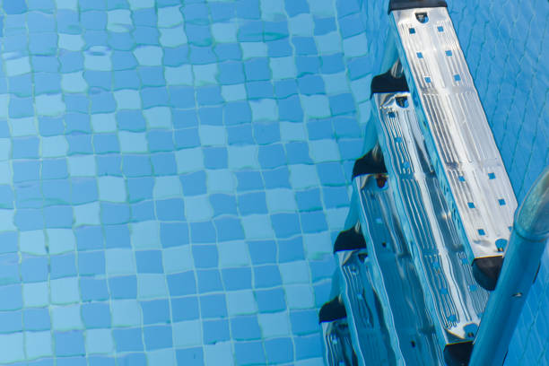istock Blue swimming pool with teak wood flooring 956188502