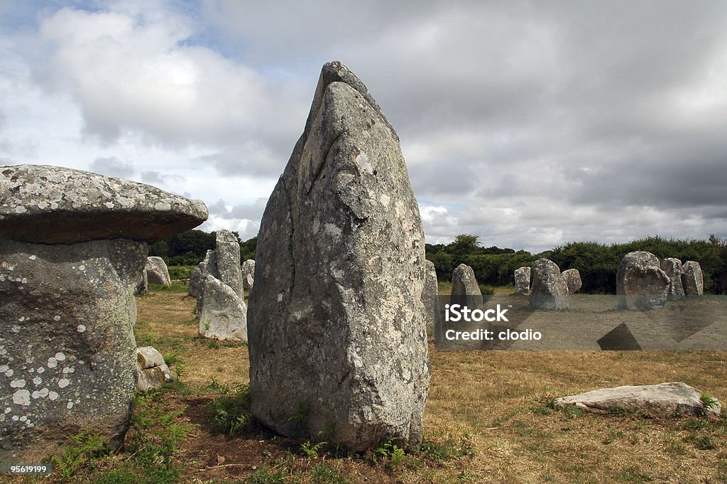 Carnac (Brittany) - Alignements, dolmens and menhirs Carnac (Morbihan, Brittany, France). Menhirs and dolmens in a meadow under a dramatic sky at summer. Megalith Stock Photo