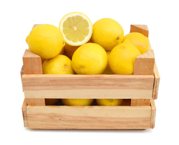 istock fresh lemons in a wooden box on a white background 956192890