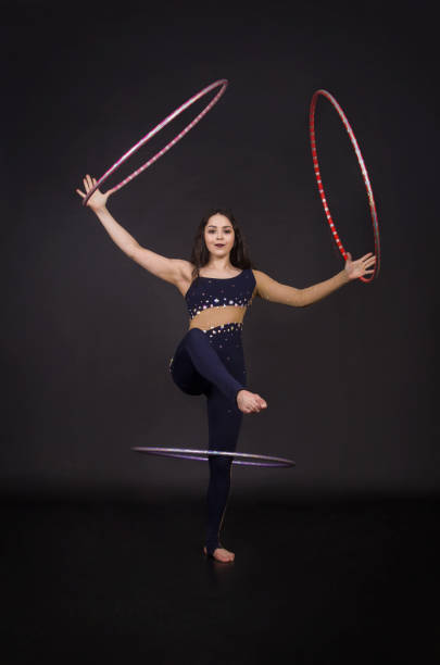 istock Gymnastic exercises with hula Hoop girl performs a circus artist. 956207424
