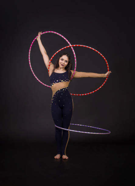 istock Gymnastic exercises with hula Hoop girl performs a circus artist. 956207444