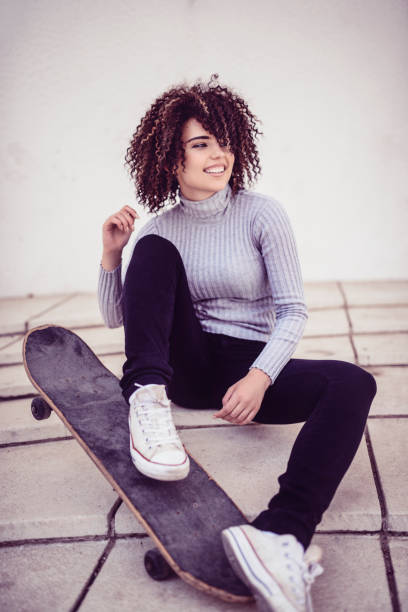 istock Beautiful Smiling Girl with Skateboard Posing on Staircase 956207826