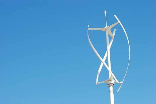 Vertical axis energy wind turbines - Copy space - Blue sky 
