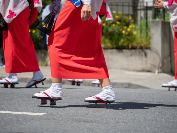 Women marching in Japanese sandals (geta) during a parade Women marching in Japanese sandals (geta) during a parade in the outdoors geta sandal stock pictures, royalty-free photos & images