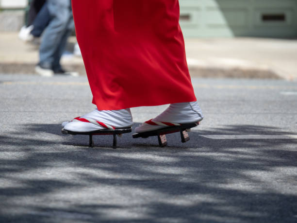 Women wearing geta, traditional Japanese footwear, on the street Women wearing geta, traditional Japanese footwear, on the street outdoors japan women human foot japanese culture stock pictures, royalty-free photos & images