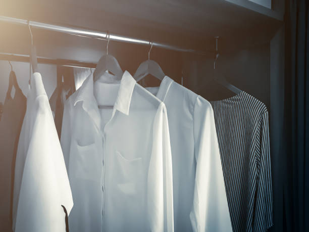 istock WHITE SOFT CLOTHS HANG IN WARDROBE INTERIOR CONCEPT 956218190
