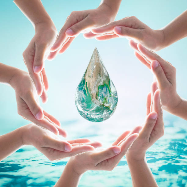 istock World ocean day,, saving water campaign, sustainable ecological ecosystems concept with green earth on woman's hands on blue sea background : Element of this image furnished by NASA 956218370
