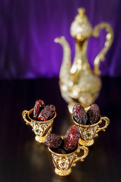 istock Still life with dates with golden Traditional Arabic coffee set with dallah and mini cup. Dark background. Vertical photo. 956218594