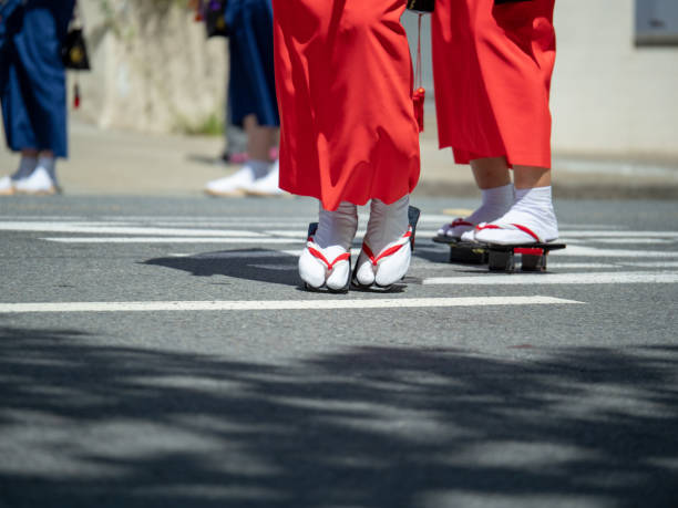 Women wearing geta footwear walking along the streets Women wearing geta footwear walking along the streets in the outdoors japan women human foot japanese culture stock pictures, royalty-free photos & images