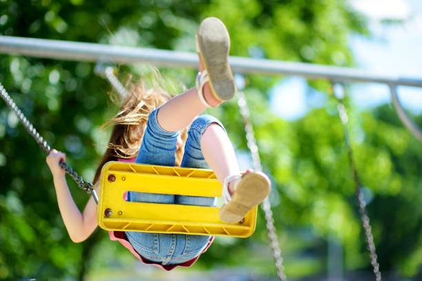 istock Cute little girl having fun on a playground 956221626