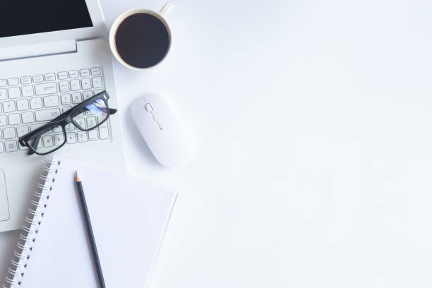 white desk office with laptop, smartphone and other supplies with cup of coffee. top view with copy space for input the text. designer workspace on desk top, view with essential elements on flat lay. - occupation office bill finance imagens e fotografias de stock