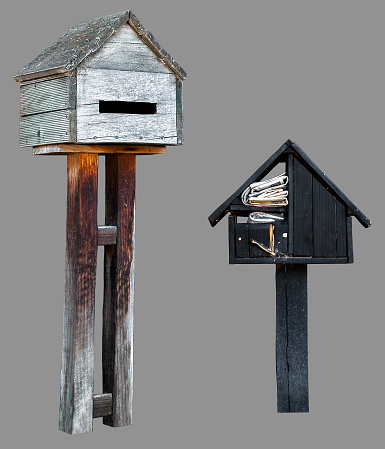 Free standing mini wooden house mailboxes, with isolated gray background and clipping path.