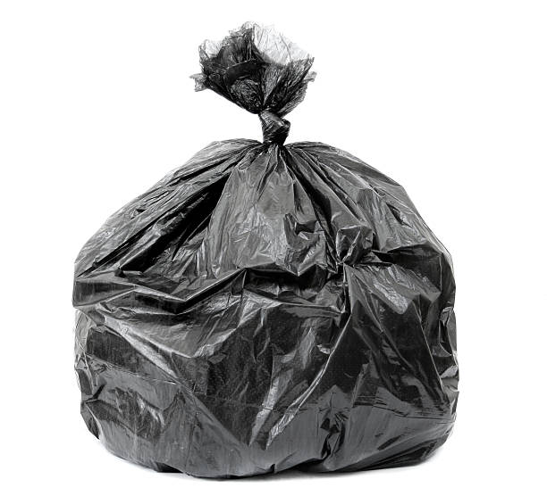 istock Large, black garage bag that is full and tied shut  95623591