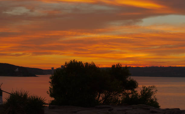 Beautiful sunrise over Balmoral Beach, Mosman Sydney. Orange filled sky and water reflection