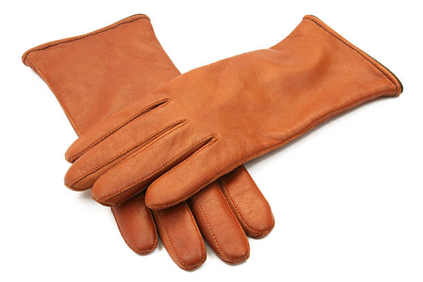 Man putting winter gloves on outside while it’s snowing