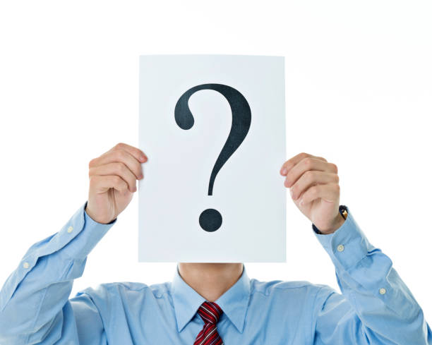istock Confused businessman holding question mark 956240720