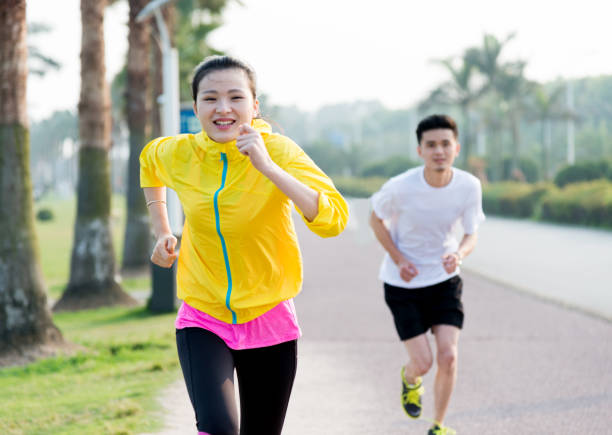 istock Young couple running together 956240750