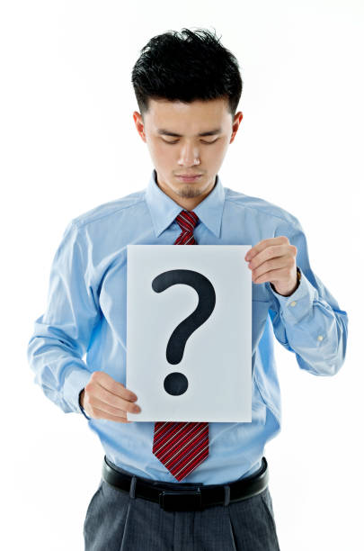 istock Confused businessman holding question mark 956240802