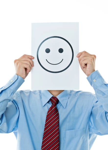 istock Businessman holding paper with smiley face 956240848
