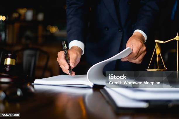 Close Up Lawyer Businessman Working Or Reading Lawbook In Office Workplace For Consultant Lawyer Concept Stock Photo - Download Image Now