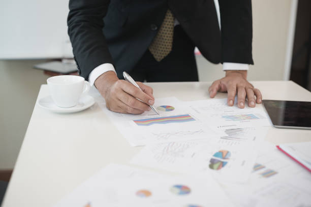 istock Hand of businessmen write business document charts at office desk. He are analyzing. brainstorming concept. 956247272