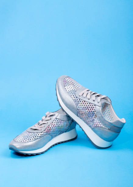 istock Gray Women's sneakers on a blue background 956252904
