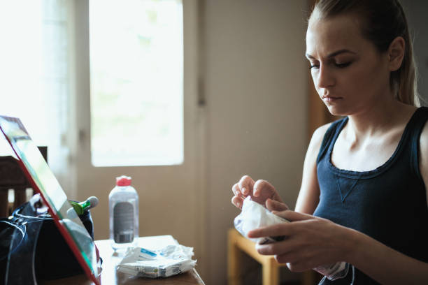 istock Young woman removing make-up and looking into the mirror 956258672
