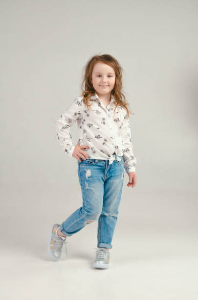 istock child in the Studio posing in fashionable clothes 956259116