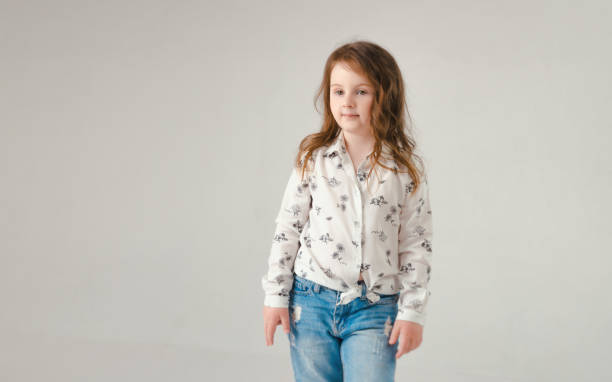 istock child in the Studio posing in fashionable clothes 956259120