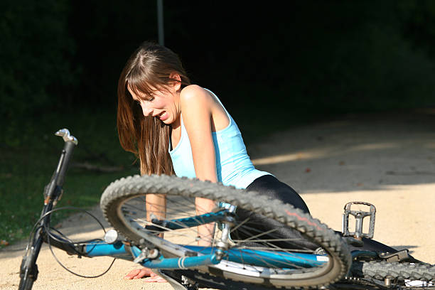 istock woman lying on the ground after bicycle crash 95626064