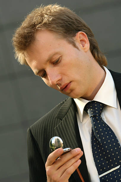 istock businessman looking at watch 95626179