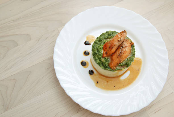 Roasted Chicken Breast and Mashed Potatoes with Spinach Sauce in White Plate. top view.