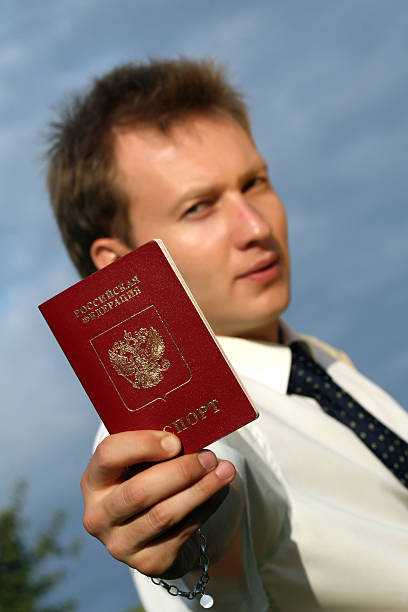 istock man holding russian passport 95626282