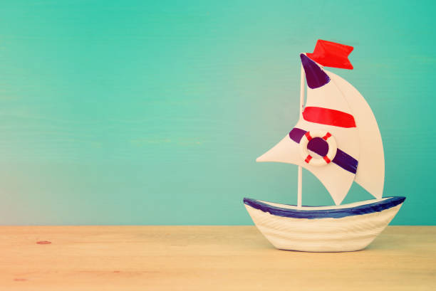 istock vacation and summer image with boat over wooden table. 956265372