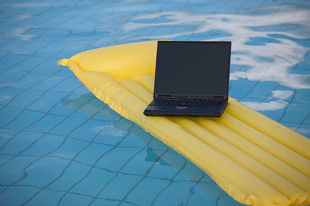 istock laptop swimming in pool 95626629