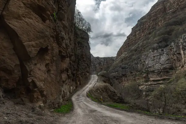 Dangerous road in mountain gorge, falling rocks