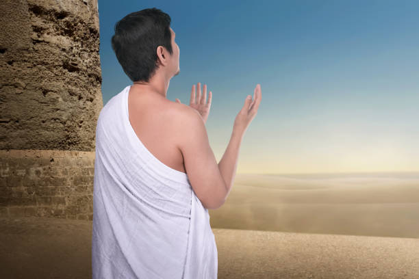 istock Back view of asian pilgrim man praying to Allah 956269482