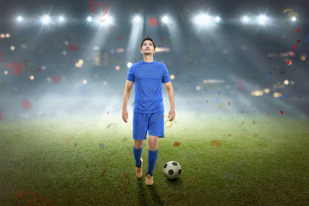 istock Professional asian soccer player man celebrate his win 956271910