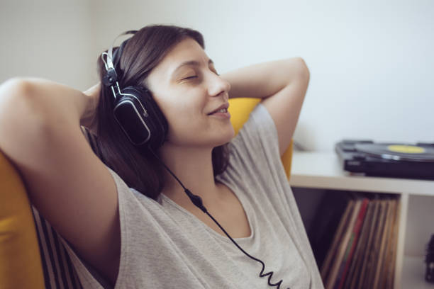 Young audiophile enjoy music on turntable