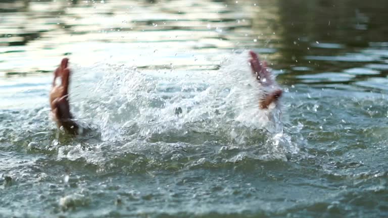 Man drowning in water. Slow motion.