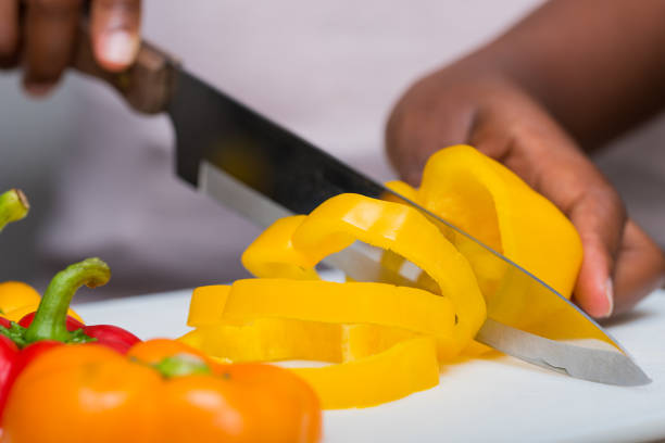 Chopping leek with kitchen knife. Close up. Photo is taken with dslr camera in studio.
