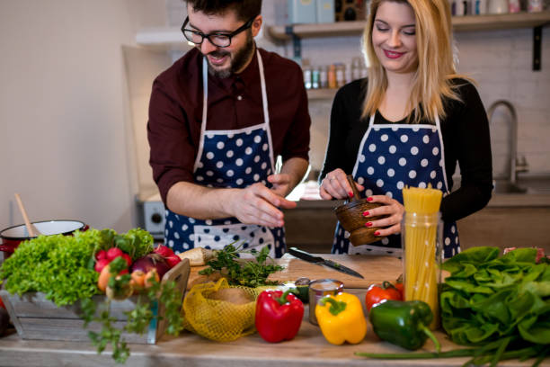 istock Smiling young couple cooking food in the kitchen 956277614