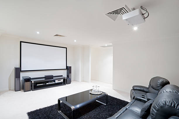 Home Theater Room with black leather recliner chairs Modern bright home theater Room with black leather recliner chairs entertainment center stock pictures, royalty-free photos & images
