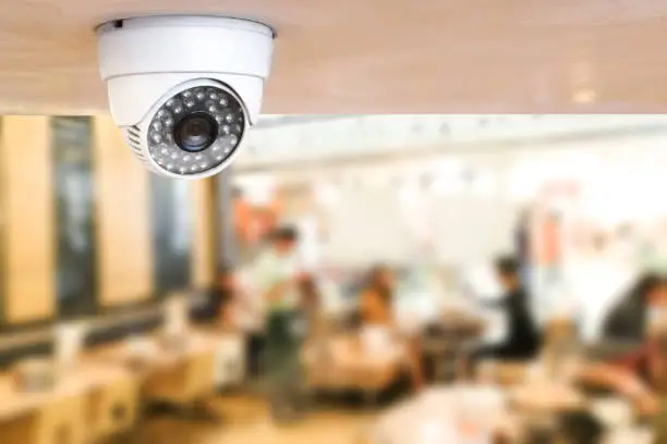 Photo of CCTV system security inside of restaurant.Surveillance camera installed on ceiling to monitor for protection customer in restaurant