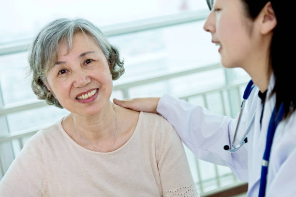 istock Female doctor with senior patient 956291186