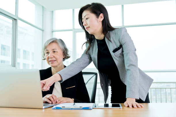 istock Two businesswomen working together in modern office 956291354