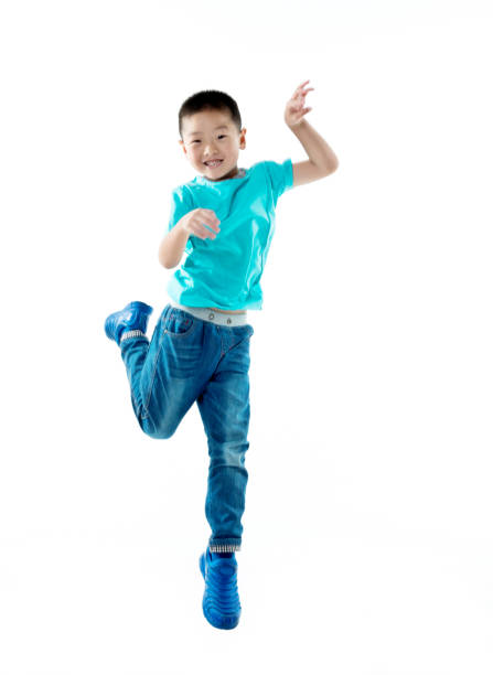 istock Young asian boy jumping against white background 956291868