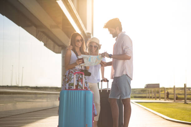 istock A very handsome young man shows directions to tourists. 956292144