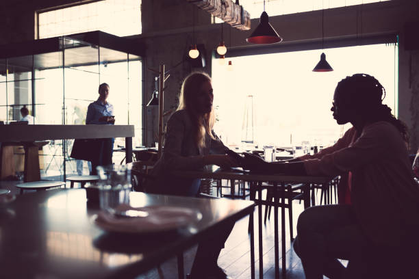 istock Two business women having coffee break in high-end restaurant 956292324